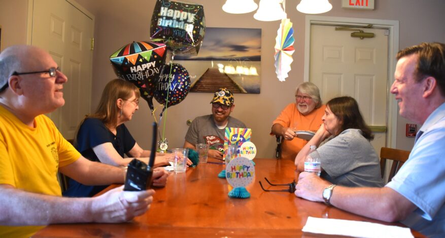 group of people around a table celebrating a birthday