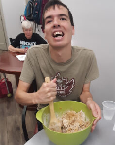 man stirring a bowl of dog biscuit batter